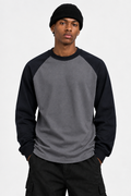 Close-up of model wearing the charcoal-and-black raglan tee 300gsm Daniel Alaves long sleeve oversized tshirt