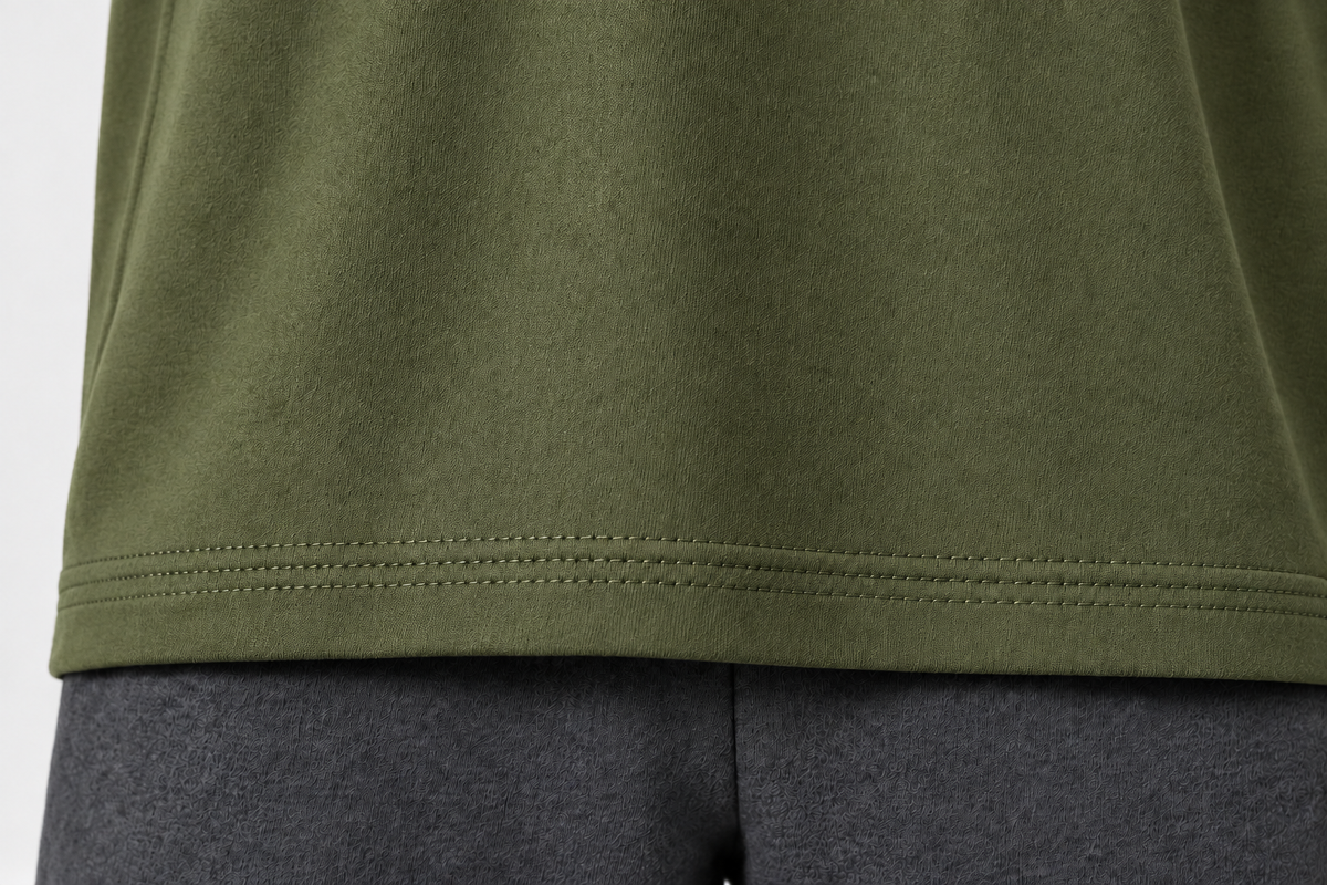 Hem of of olive-green oversized t-shirt 